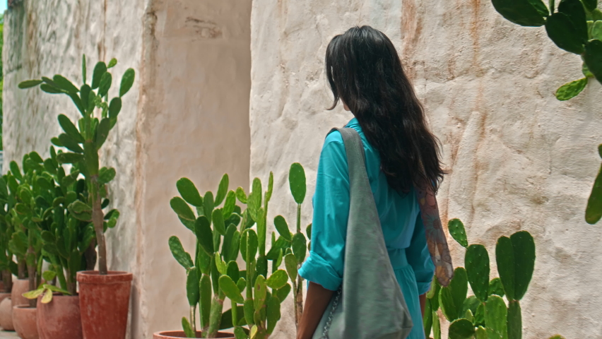 A young European girl in a blue dress and with a lady