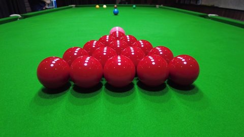 Starting shot of snooker game , cue ball striking the red balls , indoor sport concept , 4K 59.94 fps footage