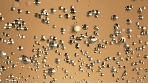 Super slow motion of champagne bubbles texture. Filmed on high speed cinema camera, 1000 fps
