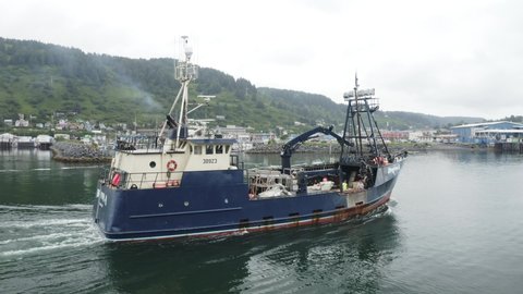 Kodiak, Alaska - Aug. 16, 2021: Deadliest Catch Crab Boat "Brenna A" Sails North out of Kodiak Harbor along the Alaska Marine Highway, Drone Orbit Shot from Starboard Side to Stern (clip 3 of 10)