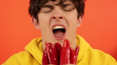 Man eating hot chili peppers.