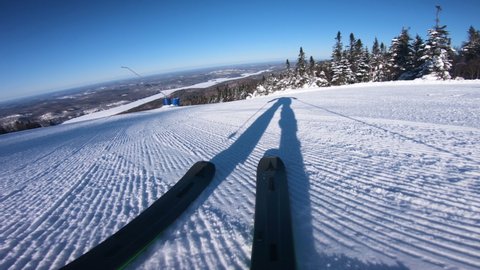 Skiing on snow slopes in the mountains, first person view POV. Man going downhill on ski having fun on slopes in Mont Tremblant, Quebec, Canada. Winter sport and outdoor activities video