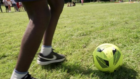 Paris , France - 08 30 2021: Close up of African American soccer player showing football dribbles and skills on the football pitch