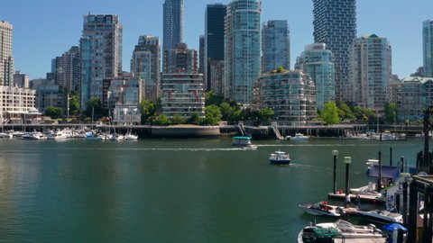 Boats And Aquabus Along False Creek For Sightseeing Services In Downtown Vancouver, British Columbia, Canada. - aerial approach