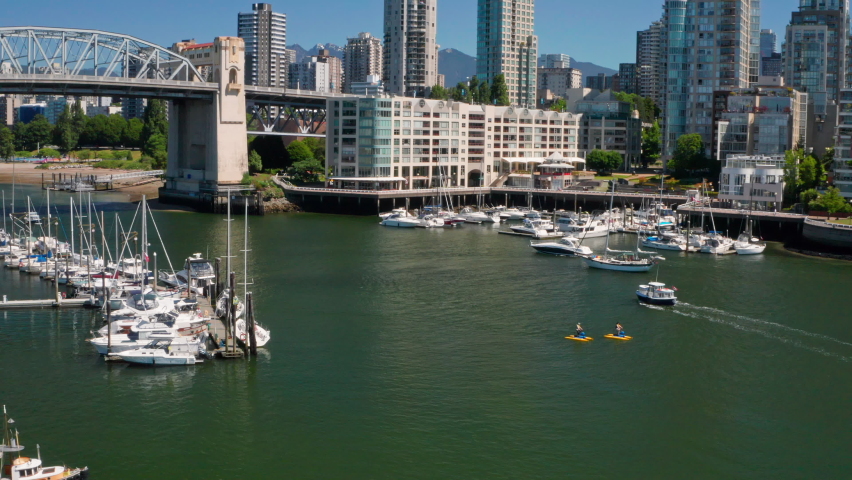 Tourists Riding Waterbike At False Creek With Sailing Boats Near Burrard Bridge IN BC, Canada. - aerial