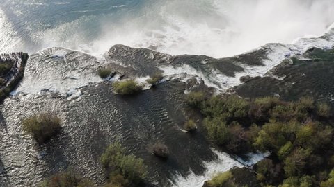 Aerial view of Niagara Falls with people watching massive water flows down the waterfall	
