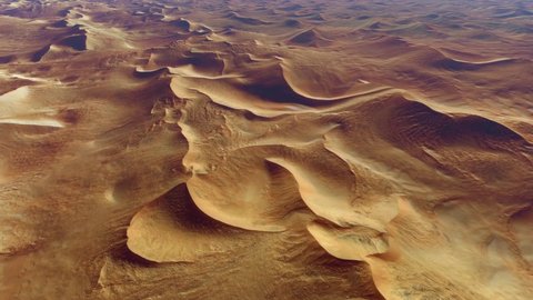 Aerial bird view of the Namib is a coastal desert in southern Africa Namibia the name is of Khoekhoegowab origin and means vast place showing brown red colored sand dunes 4k high resolution animation