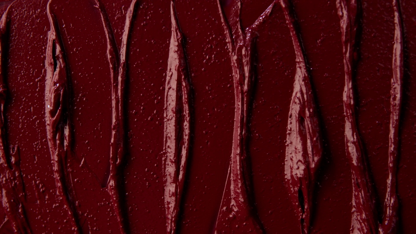 Texture of red lipstick close up. Spatula and red paint. Advertising of decorative cosmetics. Advertising concept. Move with a spatula on a red texture. Red color. Royalty-Free Stock Footage #1078520240