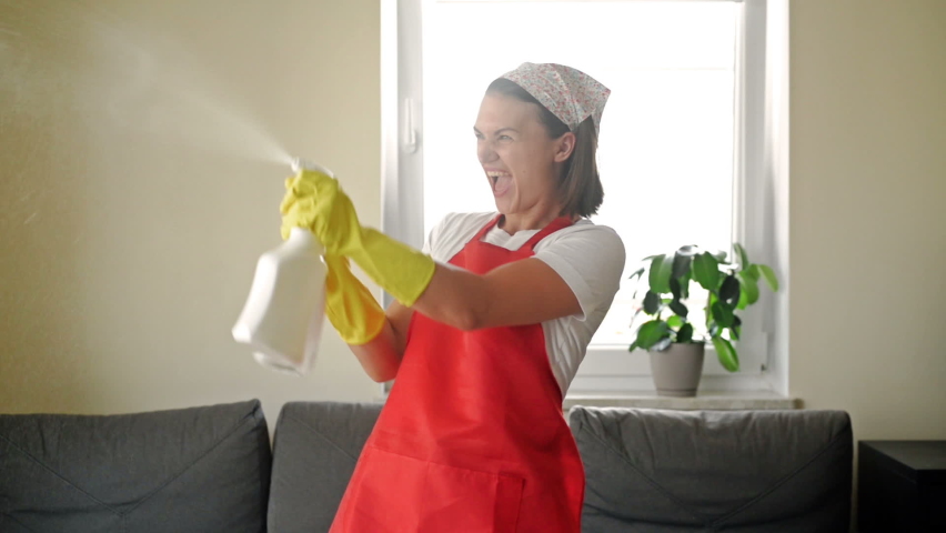 Tired of boring work, the housewife started a fun game with the Hand Sprayers. | Shutterstock HD Video #1078521743