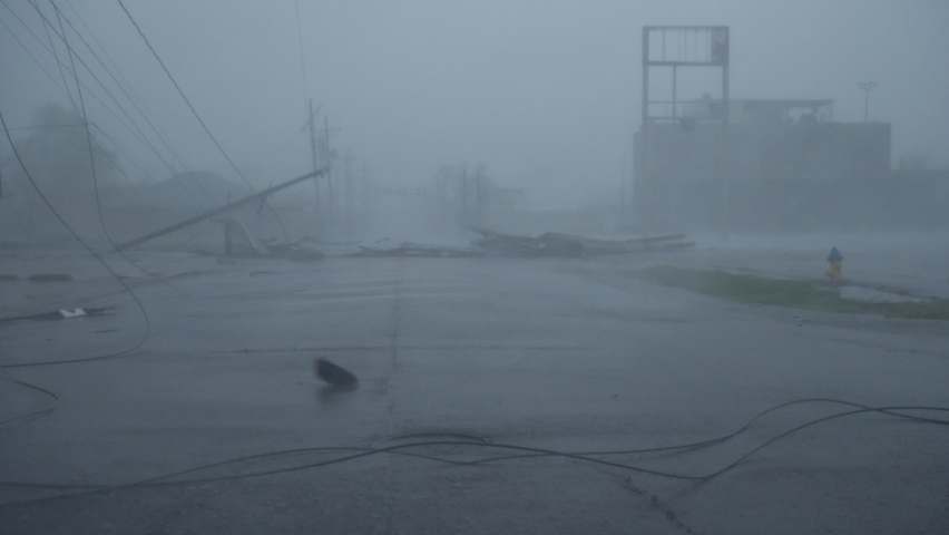 Houma, Louisiana USA - August 29 2021: Hurricane Ida Blows Debris Past Toppled Power Poles