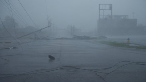 Houma, Louisiana USA - August 29 2021: Hurricane Ida Blows Debris Past Toppled Power Poles