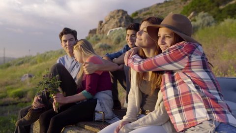 Group Of Carefree Teens Hang Out And Watch Sunset (Slow Motion)