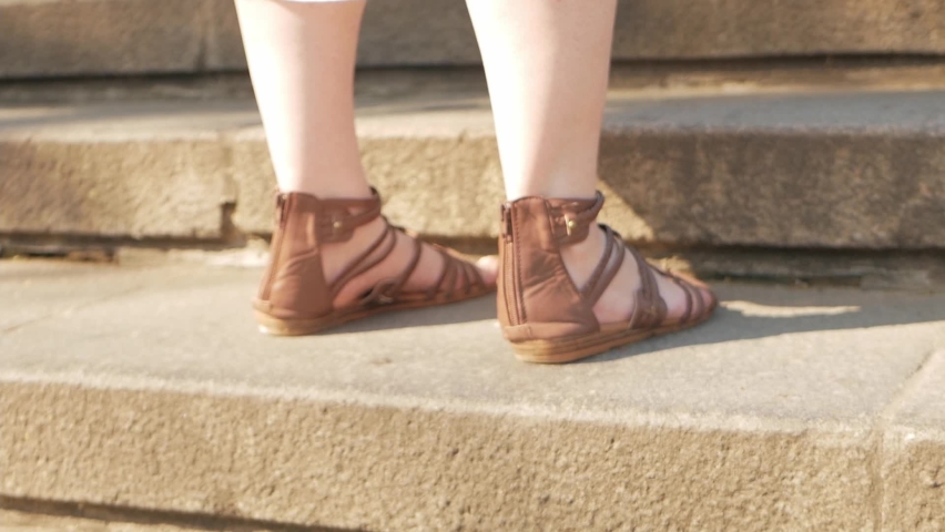 A woman in sandals and a summer dress climbs the stairs, a sunny day. Old Town Odessa. Slow motion, the tourist climbs to the top. Rest, travel, climb up. beautiful footage Potemkin Stairs