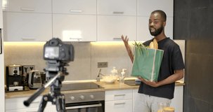 African man unpacking groceries in the kitchen