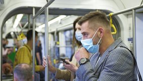 Adult man wearing protective mask coughing in a public transport. Woman afraid and keeping social distance. Pandemic and quarantine concept - Powered by Shutterstock - Get 15% off with code: PIKWIZARD15