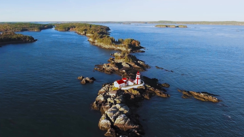 Aerial camera moving to the Head Harbour Lightstation on Campobello Island, New Brunswick, Canada, drone footage Royalty-Free Stock Footage #1078560122