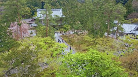Kyoto, JAPAN - Apr 3 2021 : Handheld shot of Top View from the 2nd story of the Nanzen-ji Sanmon gate at Nanzenji Temple, headquarters of the Nanzen-ji branch of Rinzai Zen, with tourists and Sakura