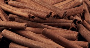 Cinnamon sticks rotate as a background. Fragrant cinnamon close-up. Spices with cinnamon. Food cooking video concept.
