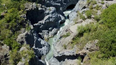 Aerial shot with drone of the Alcantara river with the gurne of Etna, small lakes created by the erosive action of the river on the lava flows. Sicily Etna. Rich flora and fauna in Sicily.