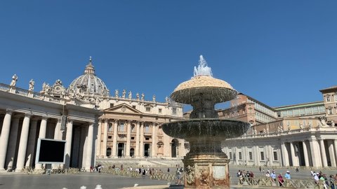 Vatican city, Vatican - August 9, 2021: Running water fountain at famous Saint Peter's Square (Piazza San Pietro). Skyline of Vatican city. St. Peter's Basilica (Basilica di San Pietro).