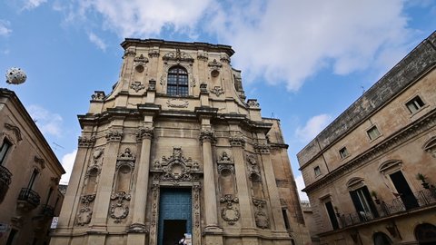 Lecce, Puglia, Italy. August 2021. Tilt footage of the facade of the church of Santa Chiara in the historic center.