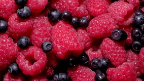Berries. Dolly shot. Various colorful berries rotation background. Raspberry, Blueberry close-up rotating backdrop. Bio Fruits, Healthy eating, Vegan food, diet. 4K UHD video