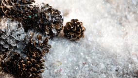 Animation of snow falling over pine cones. christmas, winter, tradition and celebration concept digitally generated video.