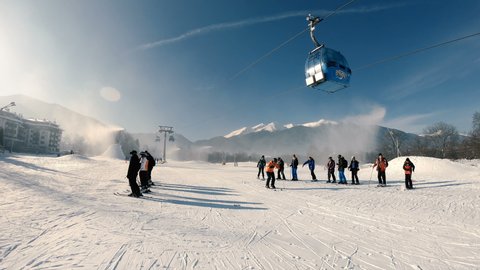 Bansko, Bulgaria - 22 Feb, 2021: Winter ski resort Bansko, ski slope, people taking lessons skiing, slow motion