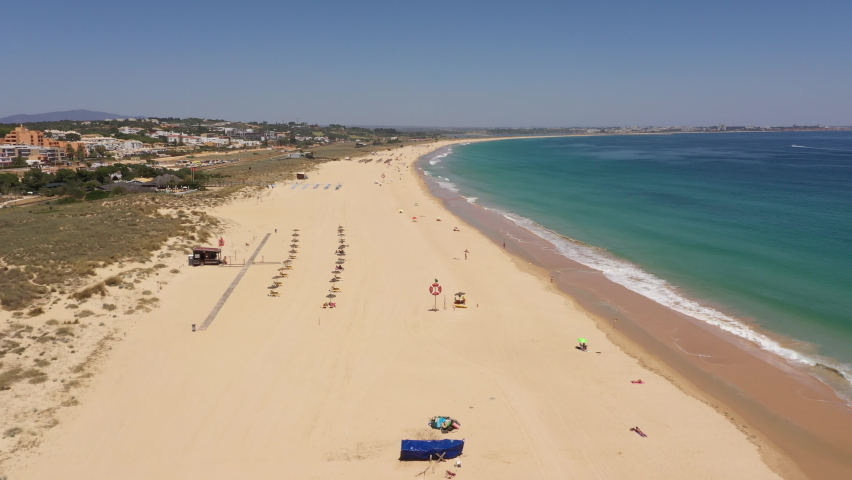Drone flight over beautiful sandy beaches in Lagos, as people return to Portugal after Covid-19 lockdown measures are eased
 Royalty-Free Stock Footage #1078593809