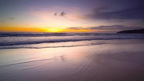 4k Nature video sunset The scenery, beaches, natural beauty and wonders.  sunset in the sea On a beautiful day, the sky is golden yellow  and the sea waves wash on the beautiful soft sandy beach