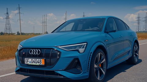 Stuttgart, Germany - May 2021: Audi customers test the new Audi e-tron electric car. Electric metallic blue Audi e-tron 55 quattro SUV.