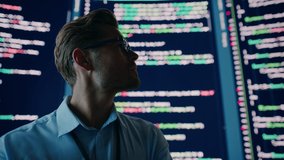 Innovative Startup: Portrait of Thoughtful Software Engineer Finding Solution, Doing Data Analysis with Big Screen Background. Programmer Developing e-Commerce App. Futuristic Dramatic Static Shot - Powered by Shutterstock - Get 15% off with code: PIKWIZARD15