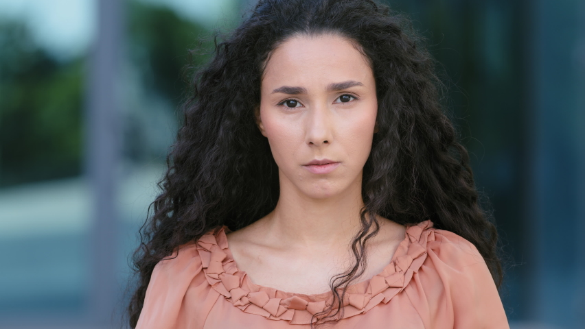 Close up upset female face of sad stressed hispanic girl ethnic woman standing outdoors looking at camera with resentful offended facial expression worry about trouble problem with health broken heart Royalty-Free Stock Footage #1078608101