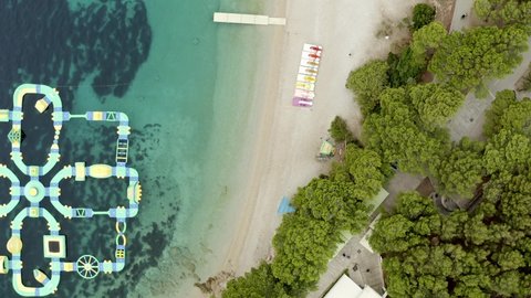 Aquapark Zlatni Rat Inflatable Playground In The Ocean Near Golden Horn Beach In Bol, Brac Island, Croatia. - aerial