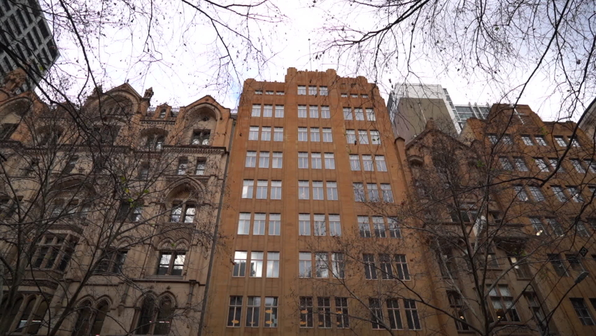 Regular tall apartment buildings in downtown Melbourne, dolly forward view