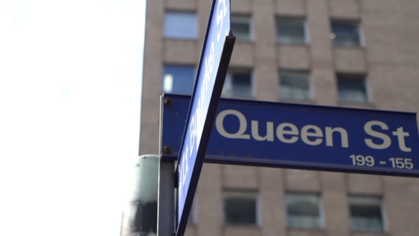 Queen street signpost with apartment building in background in Melbourne city