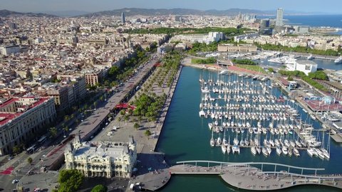 Cinematic 4K aerial drone footage of the Port of Barcelona, Moll de la Fusta with the marina and downtown Barcelona in view