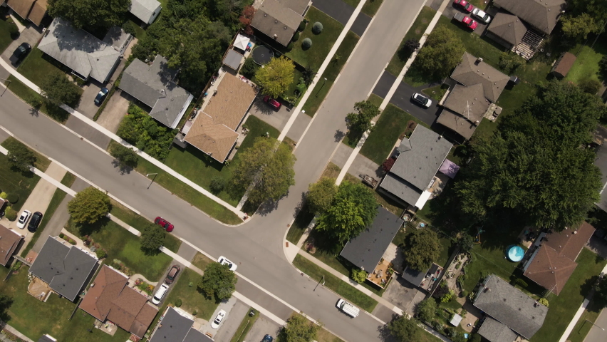 Aerial birds eye shot of Suburban Neighborhood in Welland with road and cars during sunny day - Canada,Ontario