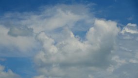 4K Time lapse, Beautiful motion white clouds on blue sky background. Video footage time lapse of puffy fluffy white clouds blue sky.