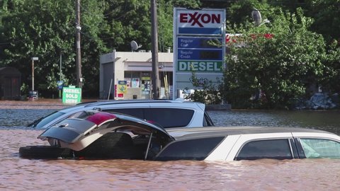 New Brunswick, New Jersey - September 2, 2021: Cars submerged under water, and flooded gas station in the aftermath of Tropical Storm Ida.