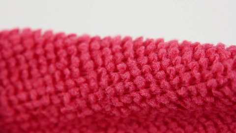 macro view on red microfiber dusting cloth, water absorbing synthetic fabric, close-up texture of textile, household cleaning equipment