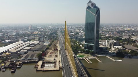 Bangkok city ,Thailand - Nov 18,2020 : Aerial scene of fly over traffic at Rama IX (Rama 9) at Chao Phraya River in Bangkok city ,Thailand