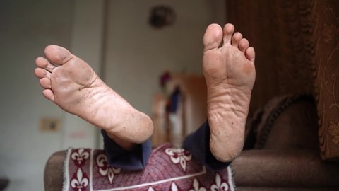 Close up of a Man dirty foot, lying on sofa, Legs Foot Close up - Selective focus