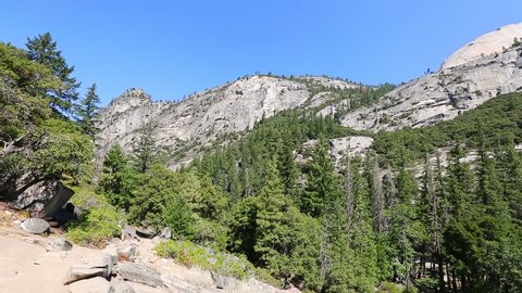 Panorama of Half Dome, Mt Broderick and Liberty Cap peaks on Mist trail in Yosemite National Park. Summer travel in California, United States.