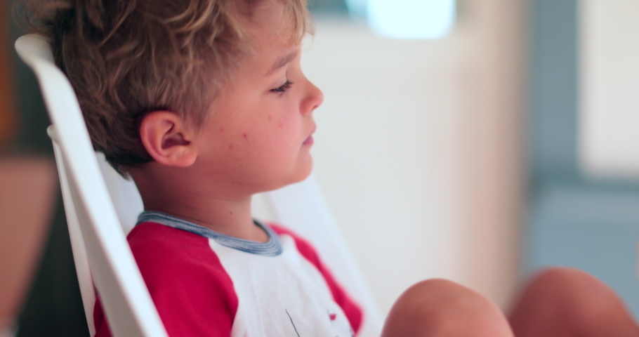 Contemplative handsome blond child boy. Pensive kid face