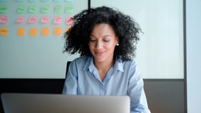 Young African American focused female executive manager businesswoman sitting at desk working typing on laptop computer in contemporary corporation office. Business technologies concept. - Powered by Shutterstock - Get 15% off with code: PIKWIZARD15