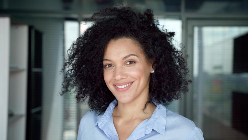 Confident happy smiling successful African American businesswoman executive manager looking at camera posing in modern contemporary corporate office. Business corporate concept. Headshot portrait. Royalty-Free Stock Footage #1078649792