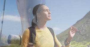 Composite of woman hiking in countryside, and admiring the view from mountain. health, fitness and wellbeing concept digitally generated video.