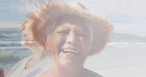 Composite of two happy senior women on beach by the sea. healthy retirement, fitness and wellbeing concept digitally generated video.