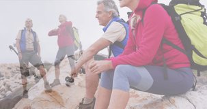 Composite of happy caucasian senior couple hiking on mountainside and looking at the view. healthy retirement, fitness and wellbeing concept digitally generated video.